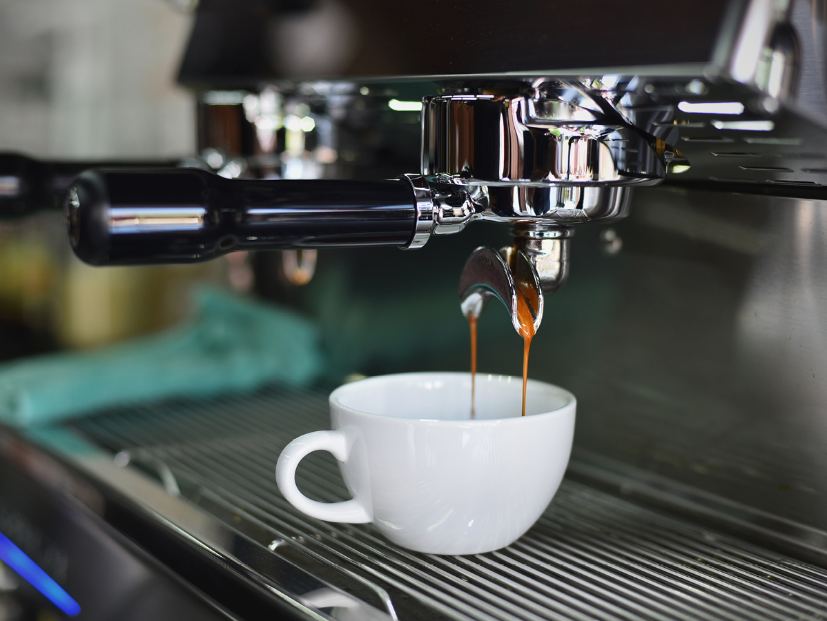 espresso machine pouring coffee into cup