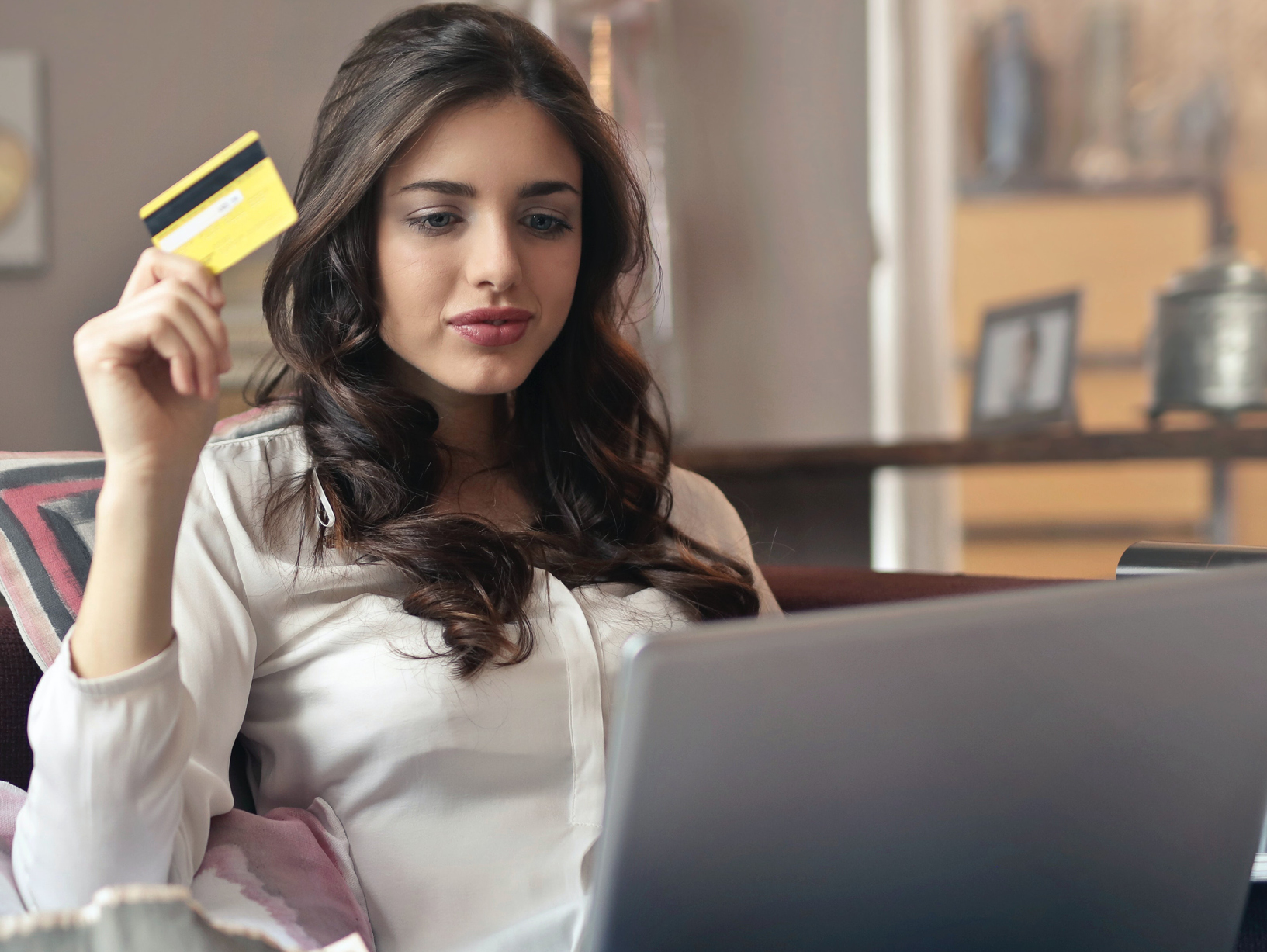 woman using credit card at computer