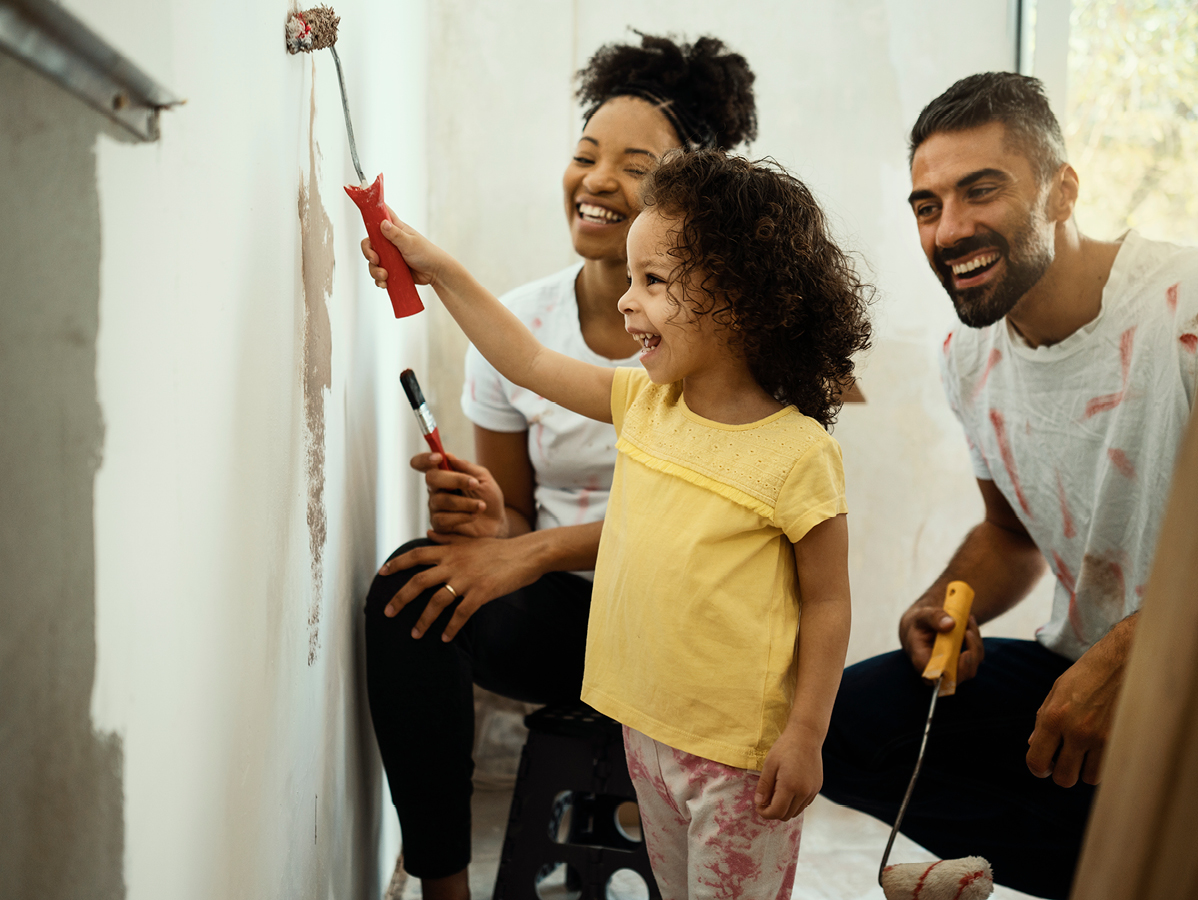 family painting a wall