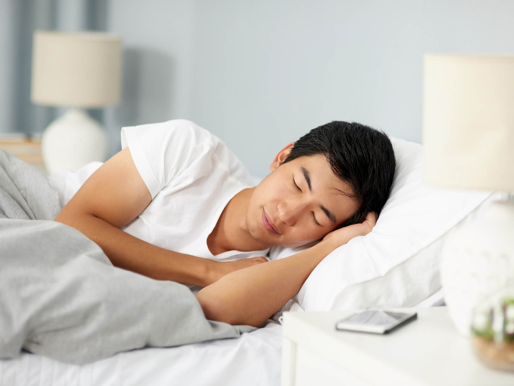 man with head on pillow in bed