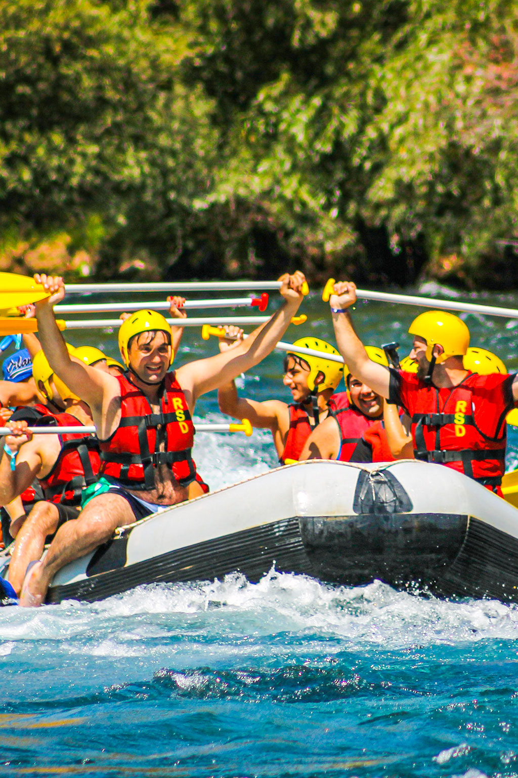 Group of young people white water rafting