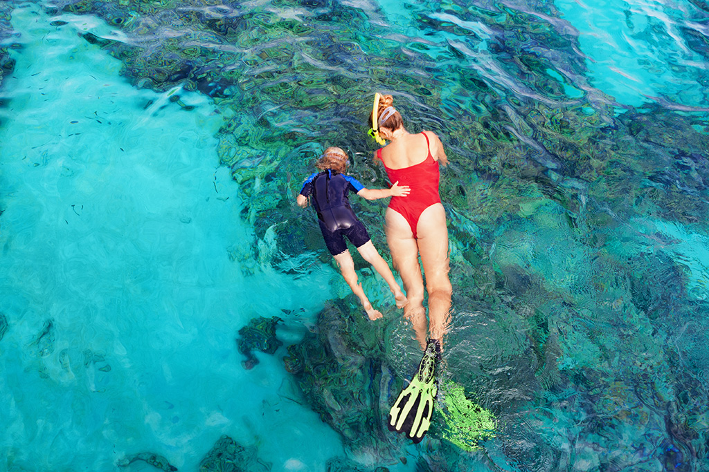 Woman and child snorkeling