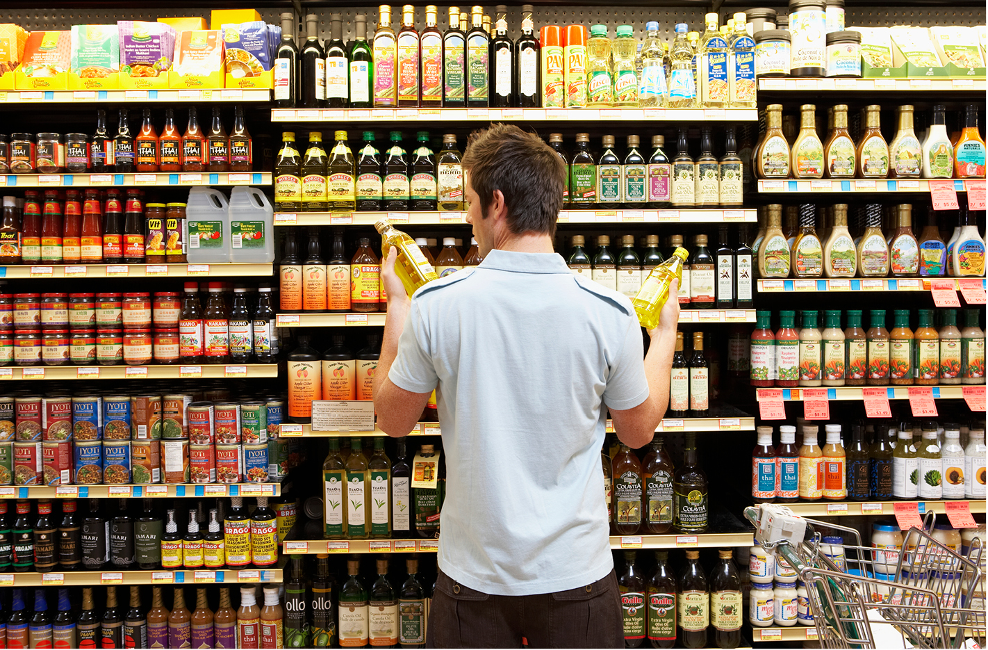 Man in grocery store looking at food label