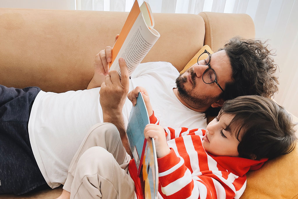 Dad and son reading book