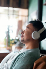 Man sitting down relaxing with headphones on