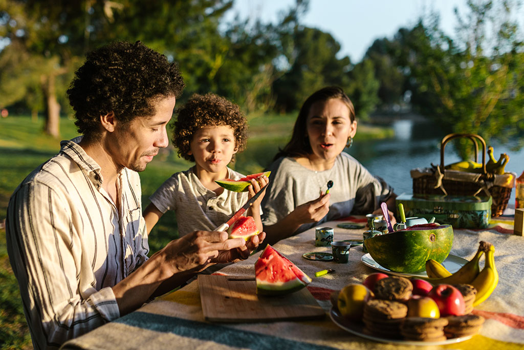 Family having picnic eating watermelon
