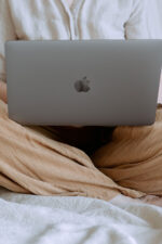 Woman on laptop sitting in bed