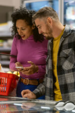 Man and woman food shopping in grocery store