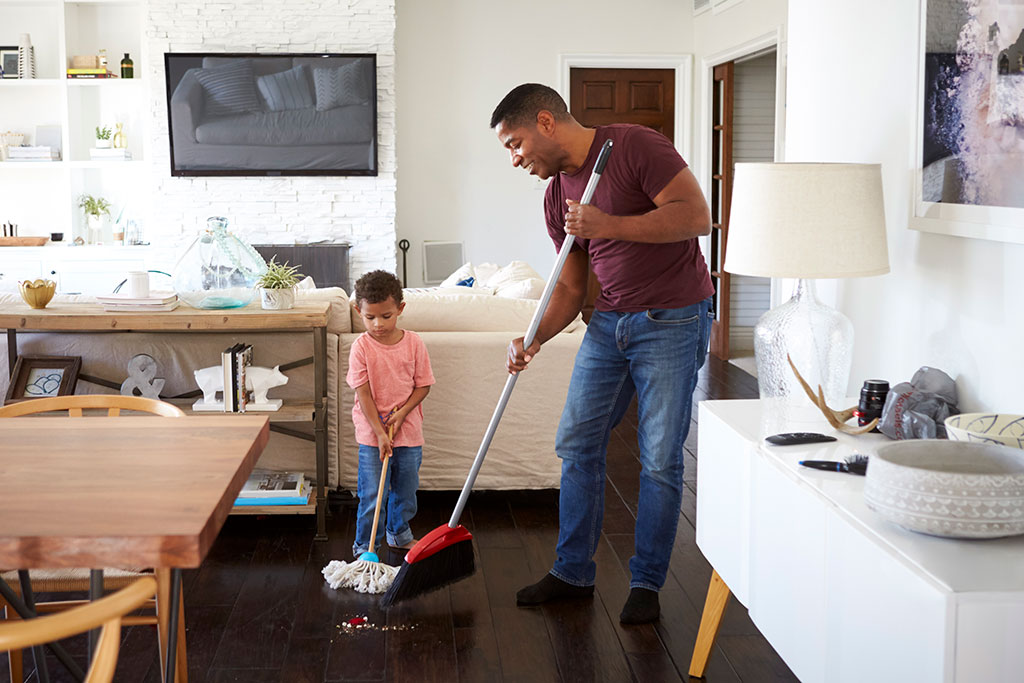 Father and son cleaning a house