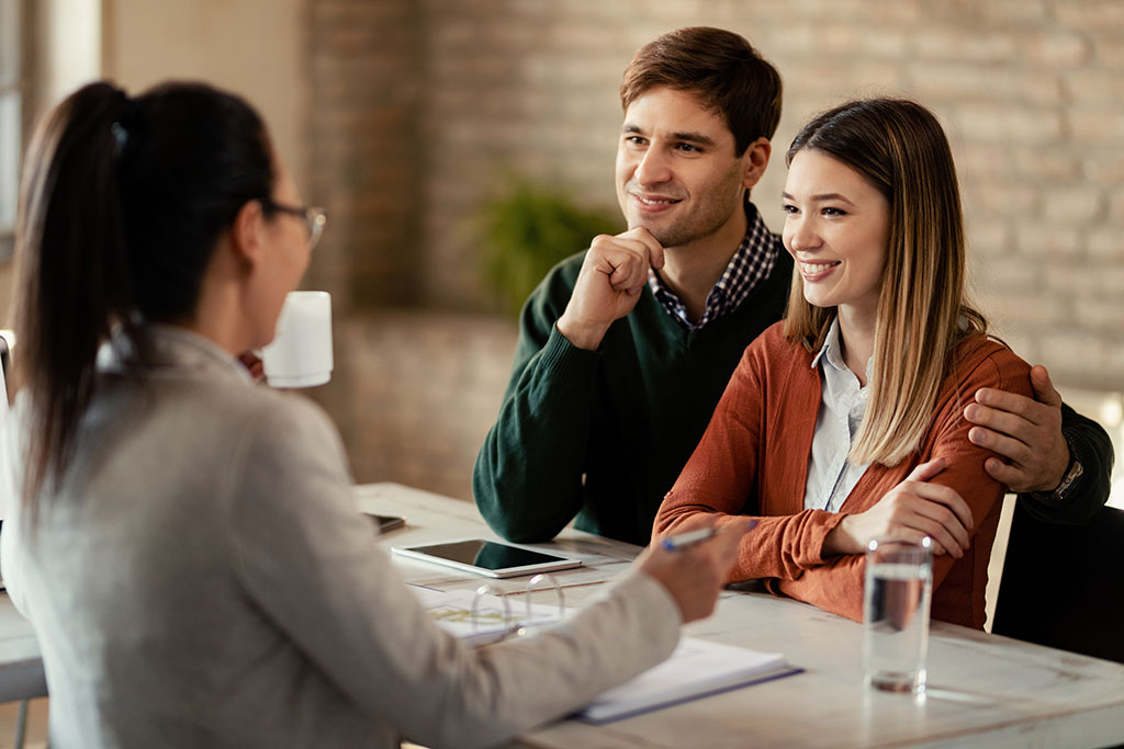 Couple talking with financial advisor