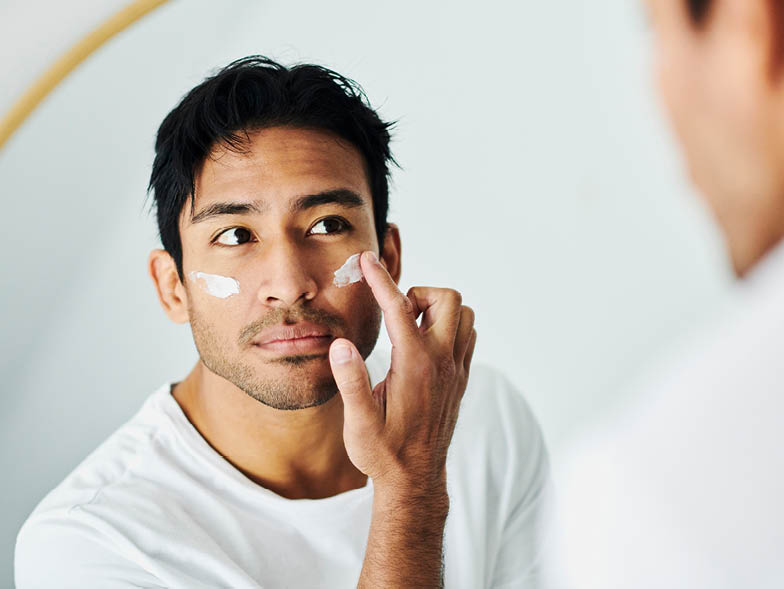 Man putting moisturizer on face
