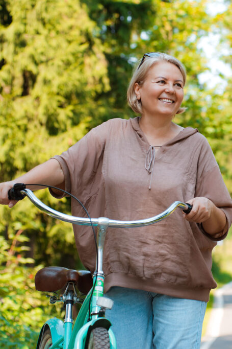 Woman walking with her bike