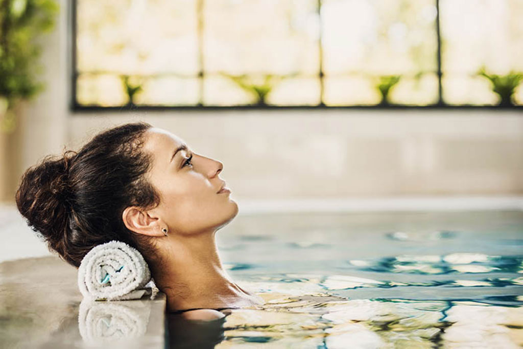 Woman relaxing in indoor pool