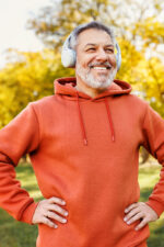 Older man working out listening to podcast