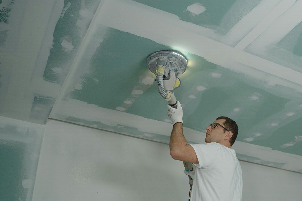 Man cleaning ceiling