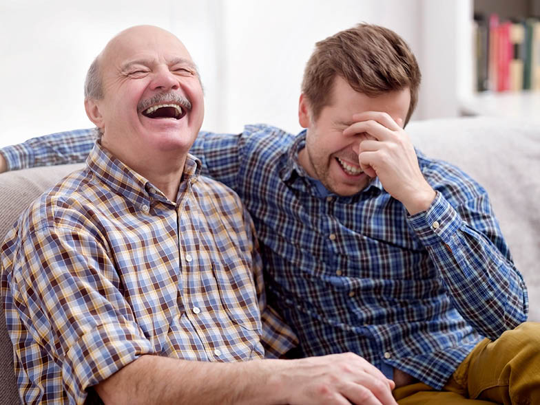 Older father and older son laughing
