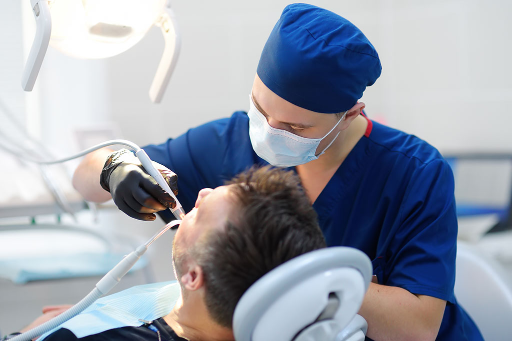 Man getting teeth cleaned by dentist in dentist office