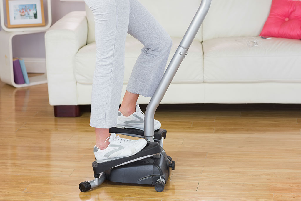 Woman using stair stepper