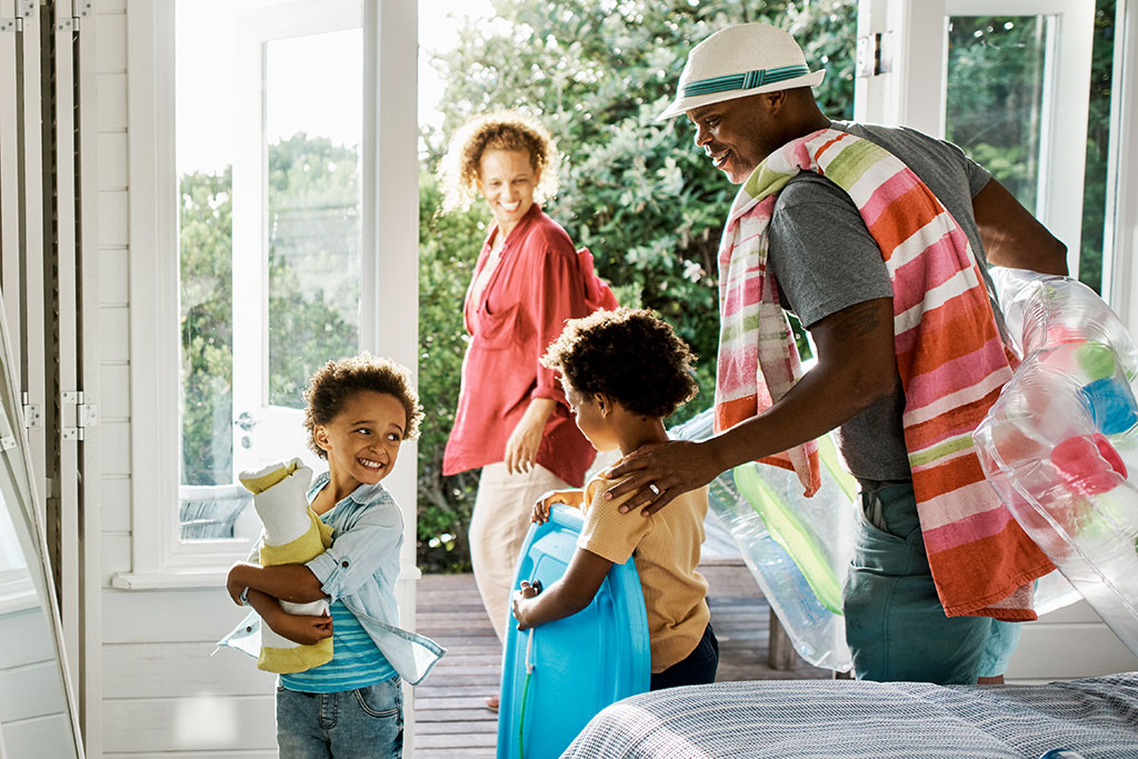 Family leaving house to go to have a beach day