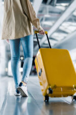 Woman going through airport with suitcase