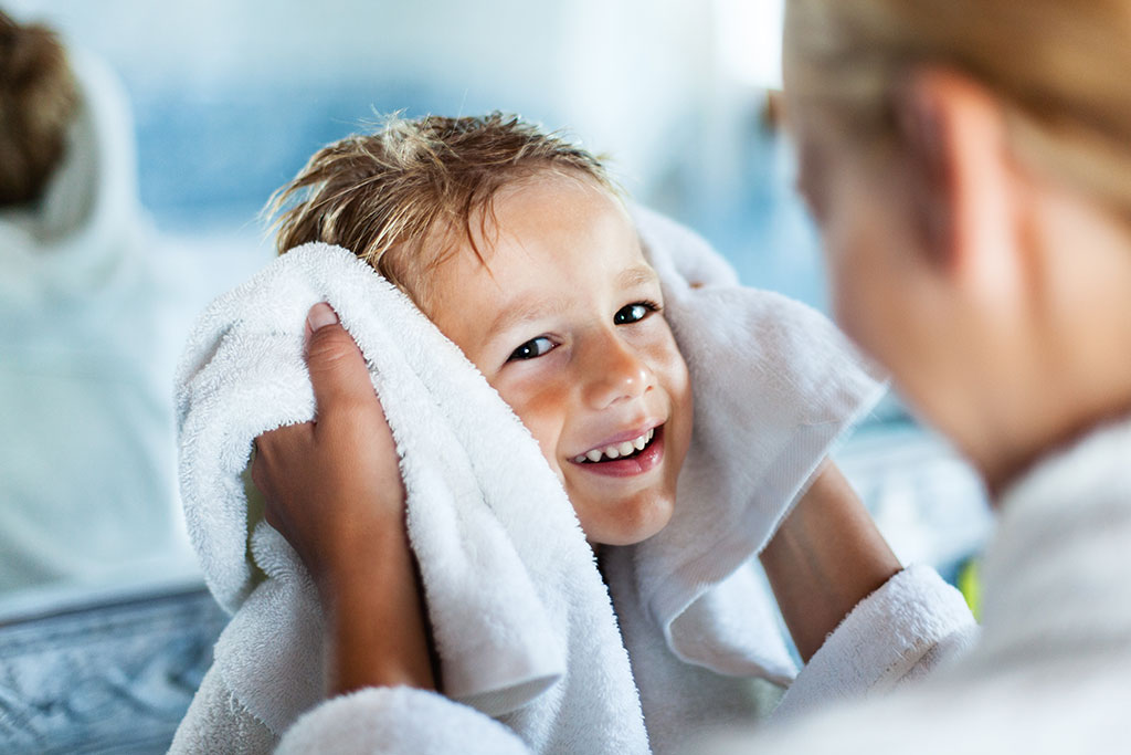 Mom drying son after bath