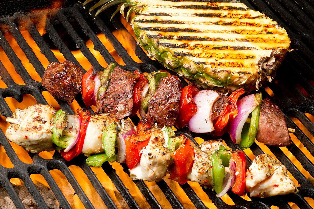 Skewers on grill with pineapple