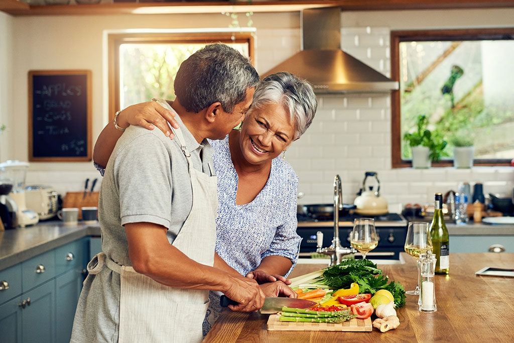 Older couple making dinner together