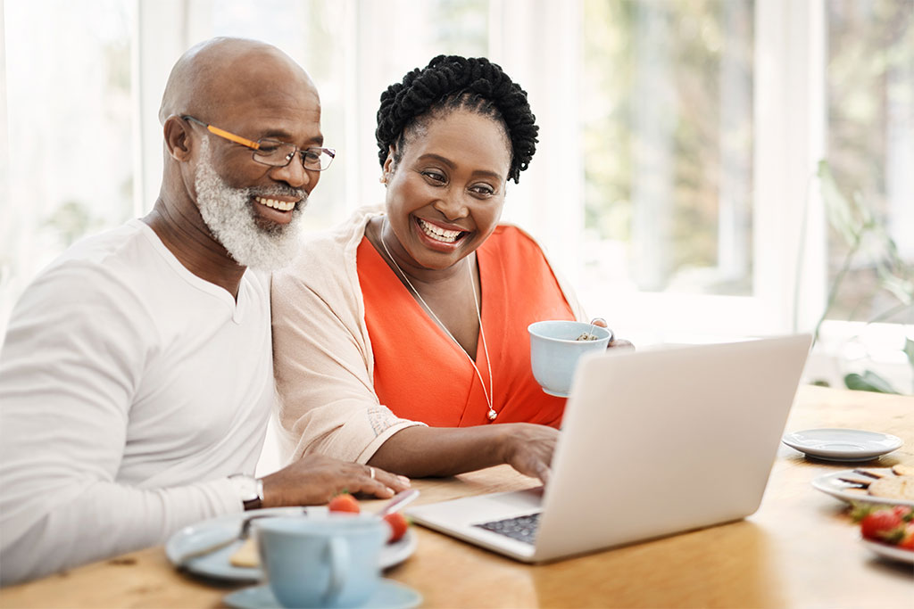 Older couple looking over finances on laptop