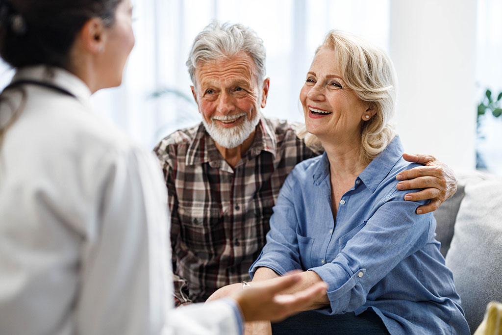 Older couple talking to medical professional