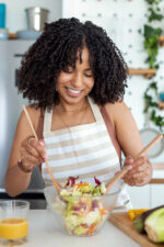 Woman mixing salad