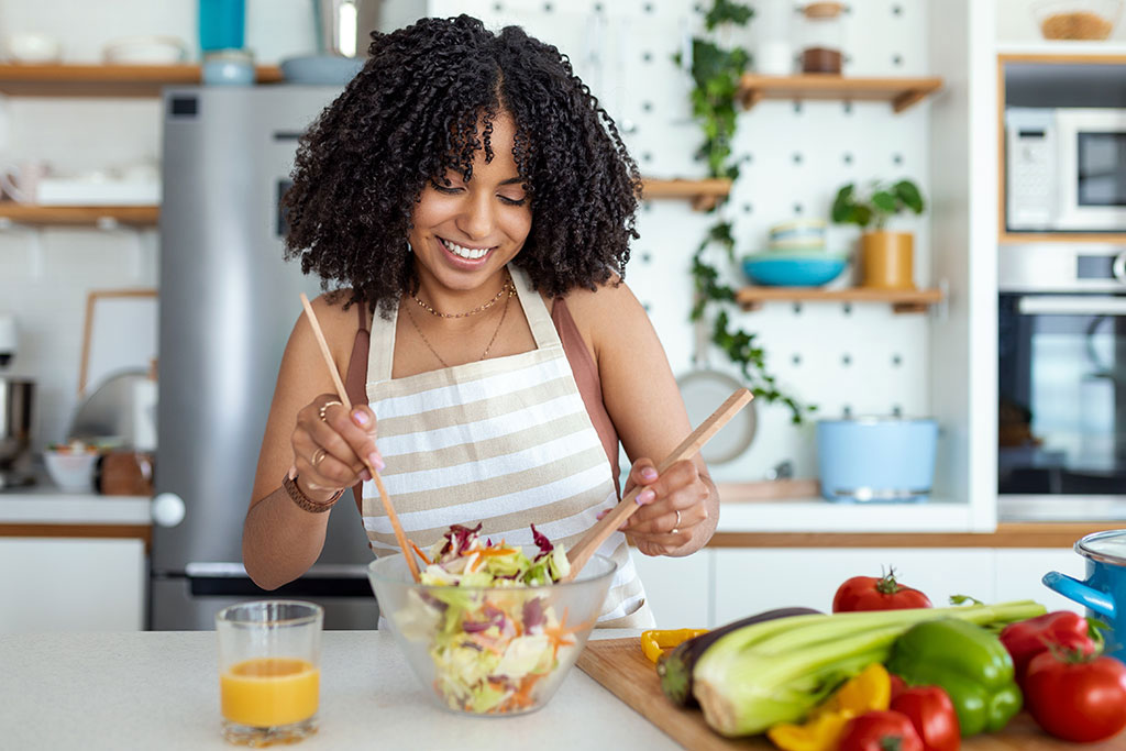 Woman mixing salad