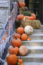 Front stairs to house decorated with pumpkins