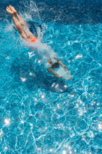 Person diving into pool