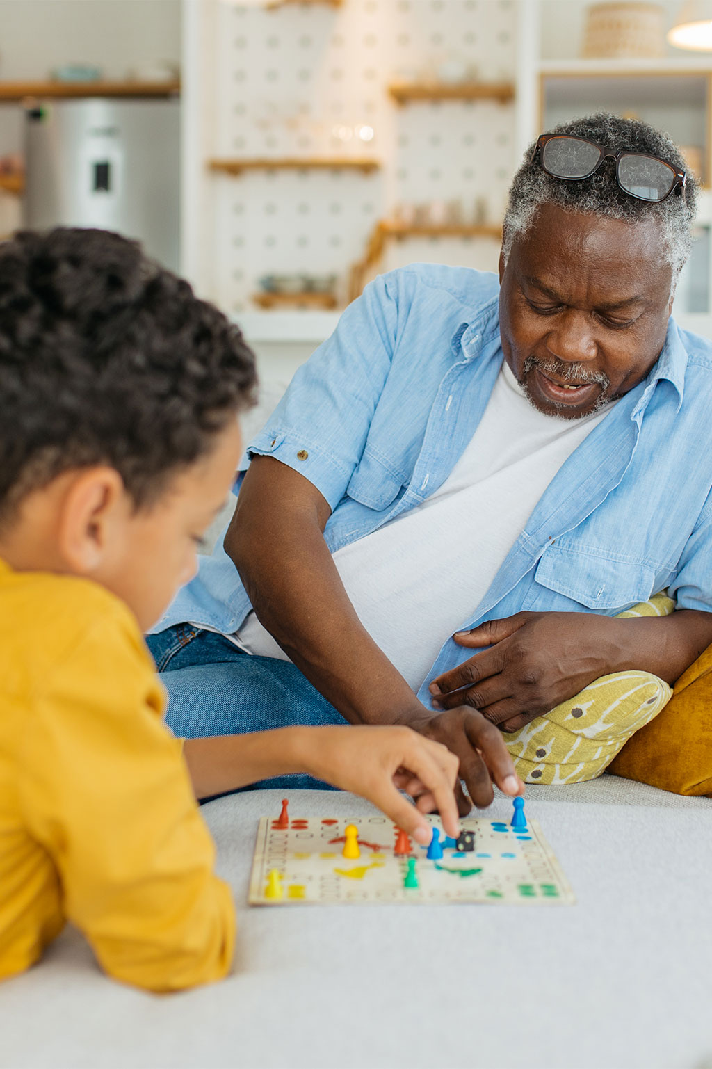 Grandson and grandpa playing board game