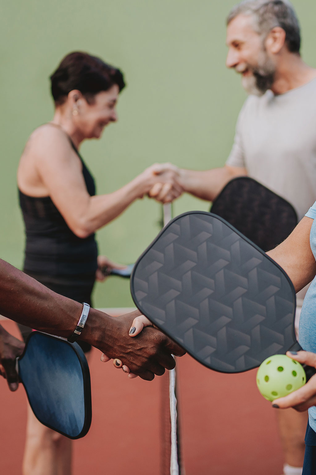 Older people playing pickle ball