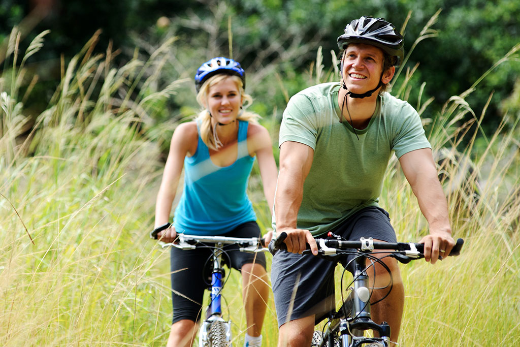 Couple riding bikes on trail