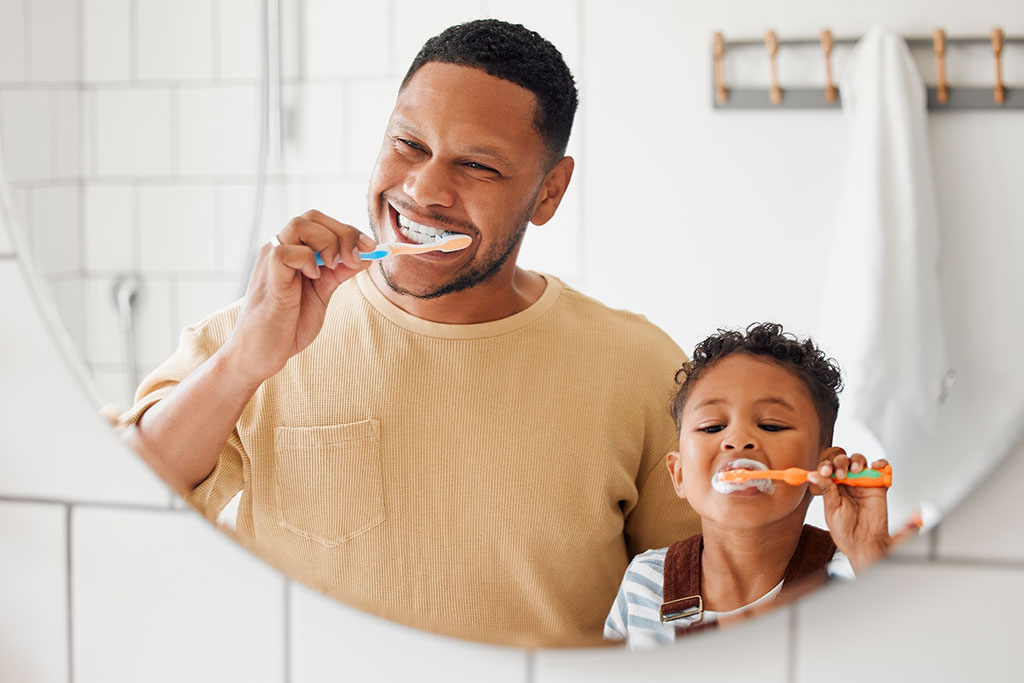 Dad and son brushing teeth
