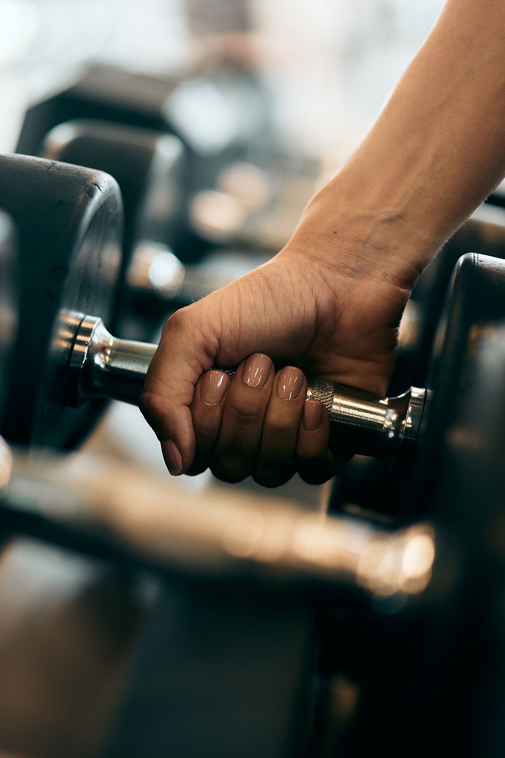 Person grabbing weight in gym