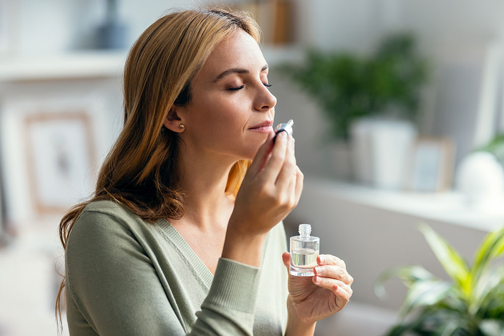 Woman smelling scent for home