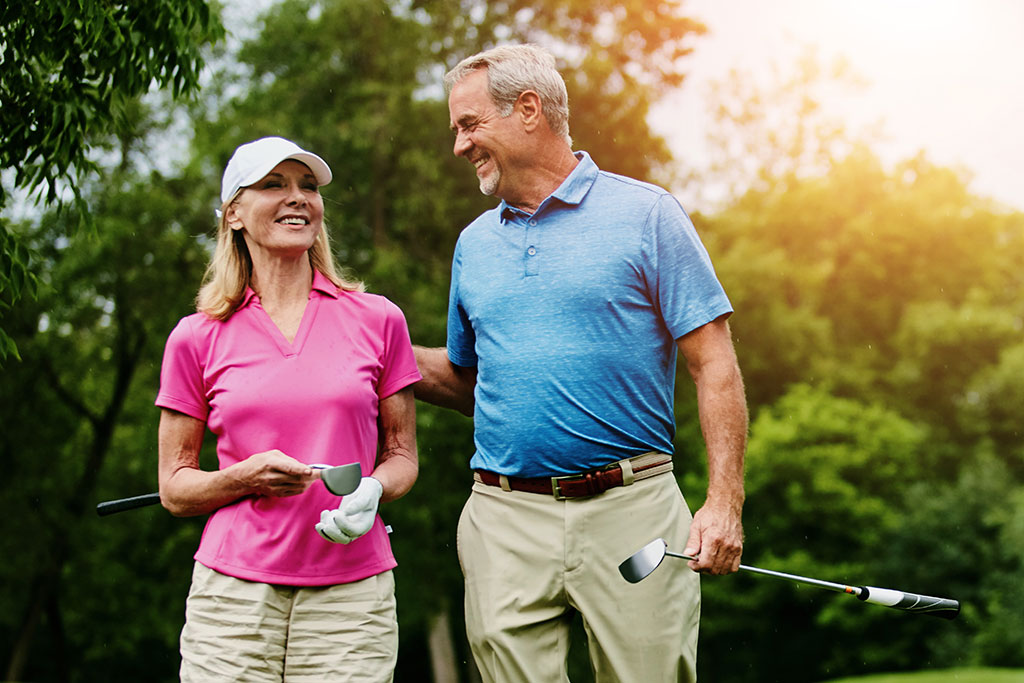 Older couple golfing