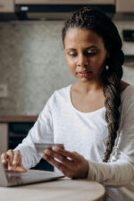 Woman going through finances on card