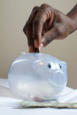 Putting money in piggy bank
