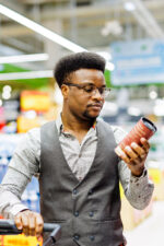 Man reading ingredient list on food label